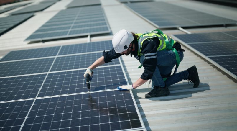 Professional worker installing solar panels on the roof. engineer working on checking equipment in solar power plant, Pure energy, Renewable energy.